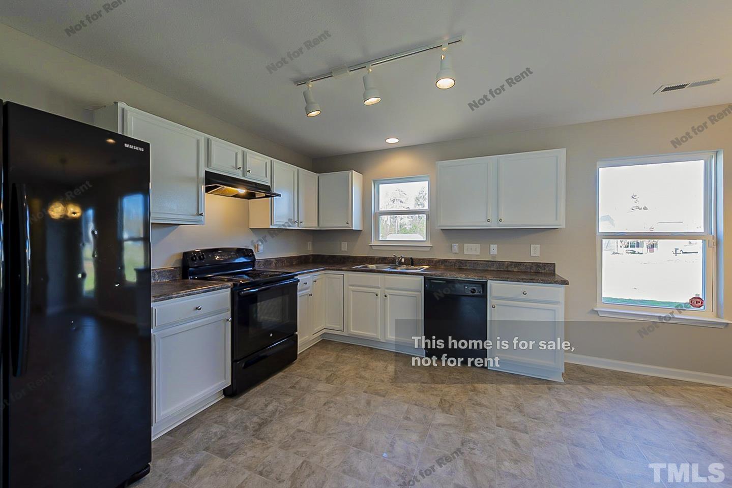 1908 Buffalo Way Durham, NC 27704 - Photo 9 of 26 a kitchen with a refrigerator and a stove top oven