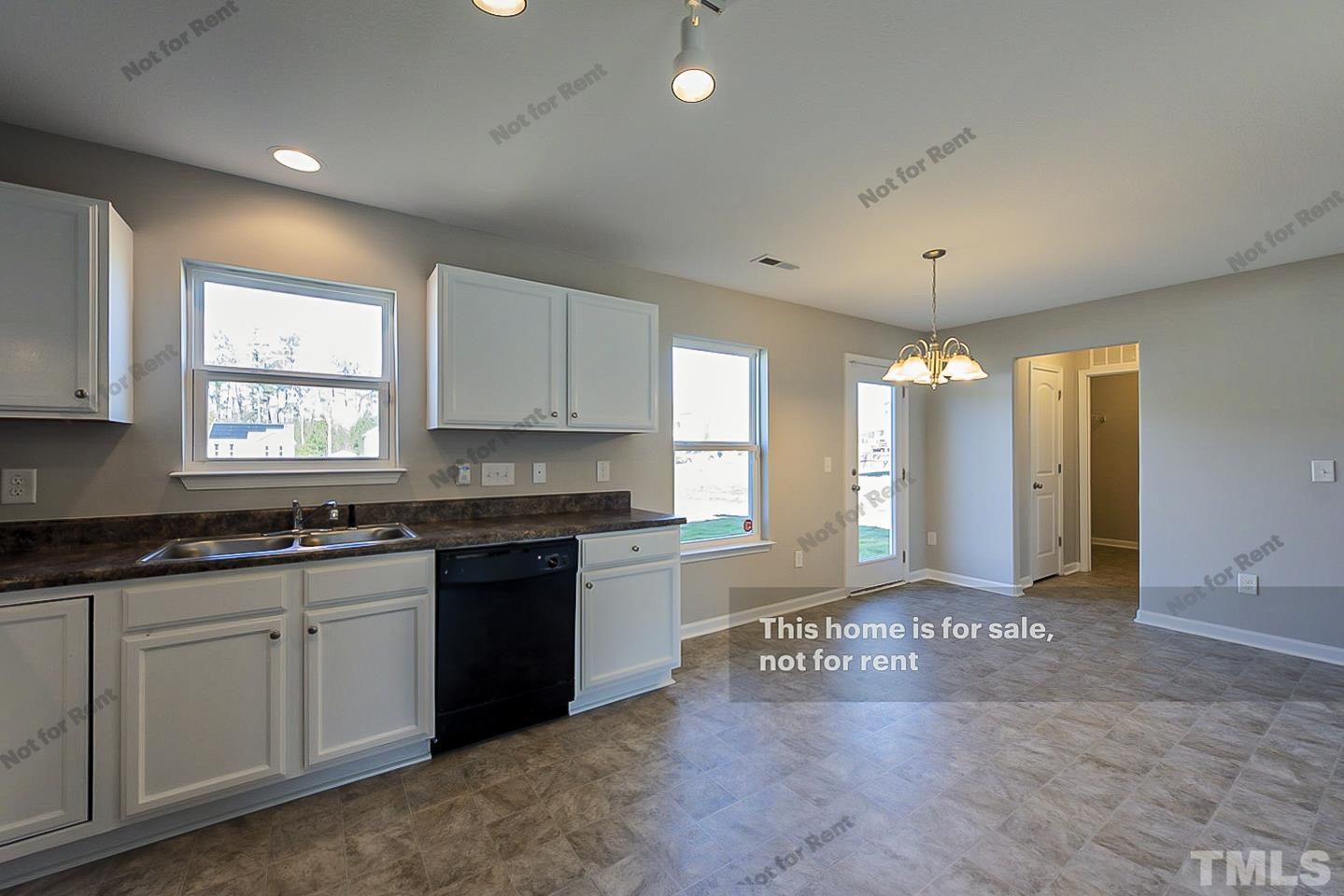 1908 Buffalo Way Durham, NC 27704 - Photo 10 of 26 a large kitchen with granite countertop a stove a sink a refrigerator and white cabinets