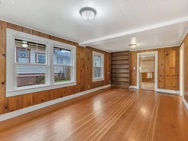 wooden floor in an empty room with a window