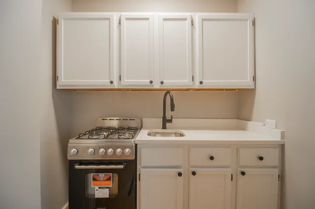 a kitchen with a stove and a sink