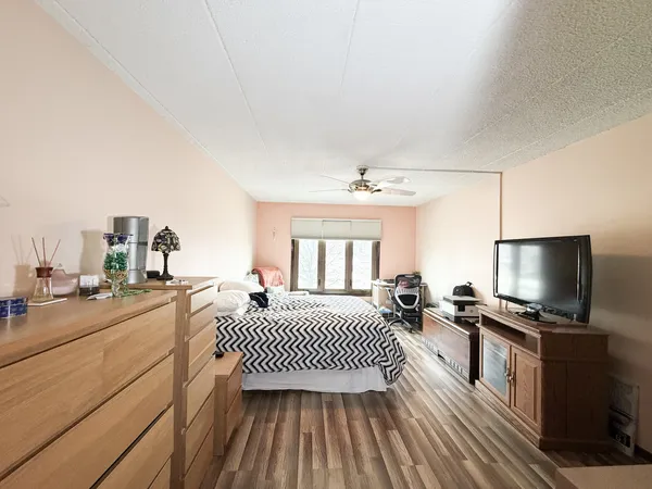 a bedroom with a bed and a flat screen tv