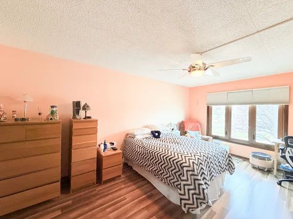 a bedroom with a bed and a night stand