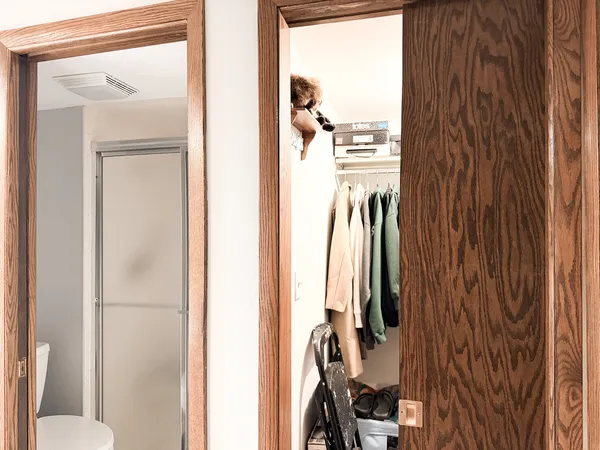 a view of walk in closet with clothes and shoes