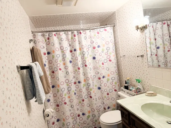 a bathroom with a sink toilet and shower