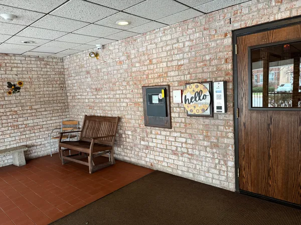 a view of a door with wooden floor and a fireplace