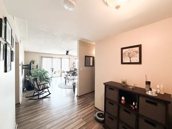 a view of a workspace with furniture and wooden floor