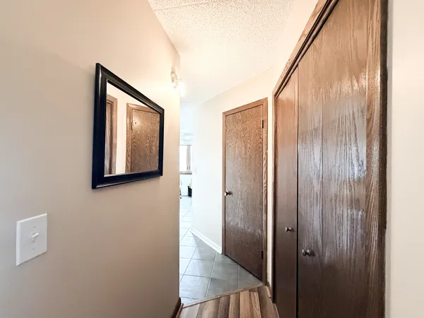 a view of a hallway with wooden floor