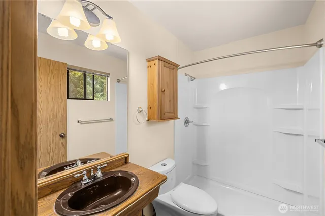 a bathroom with a sink toilet and shower
