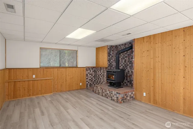 a kitchen with cabinets and wooden floor