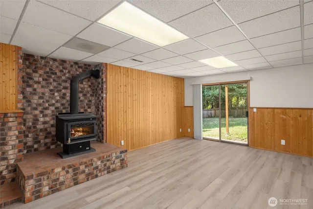 a view of an empty room with a fireplace and a window