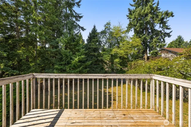 a view of wooden deck and a yard