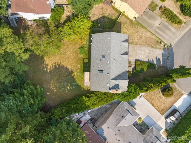 an aerial view of a house with garden space and street view