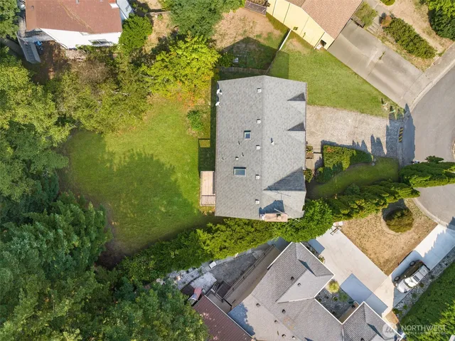 an aerial view of a house with garden space and street view