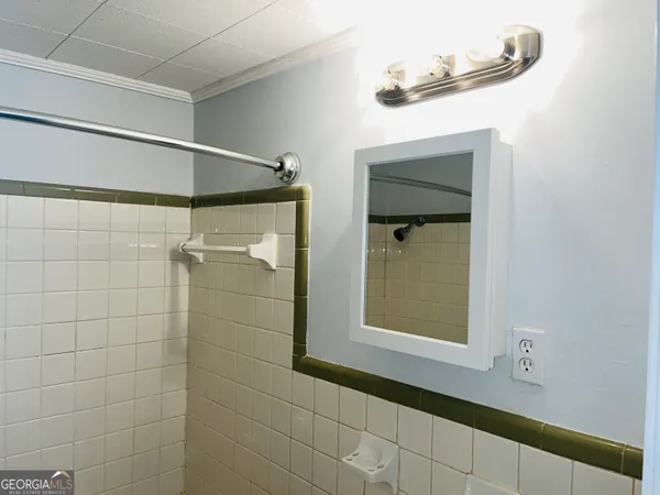 a bathroom with a shower and a mirror