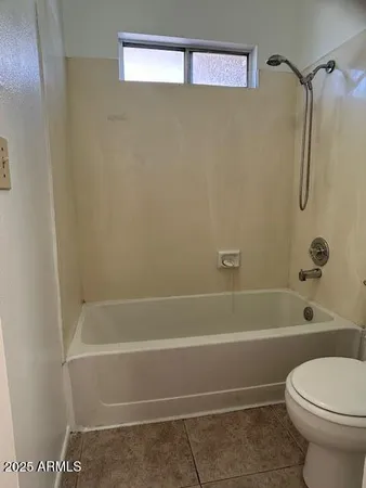 a bathroom with a shower and a toilet