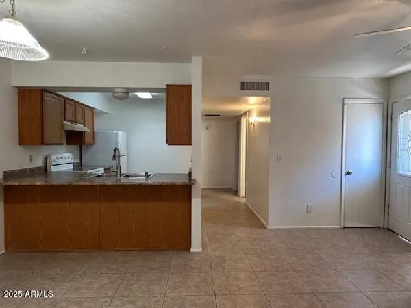 a kitchen with stainless steel appliances granite countertop a refrigerator and a sink