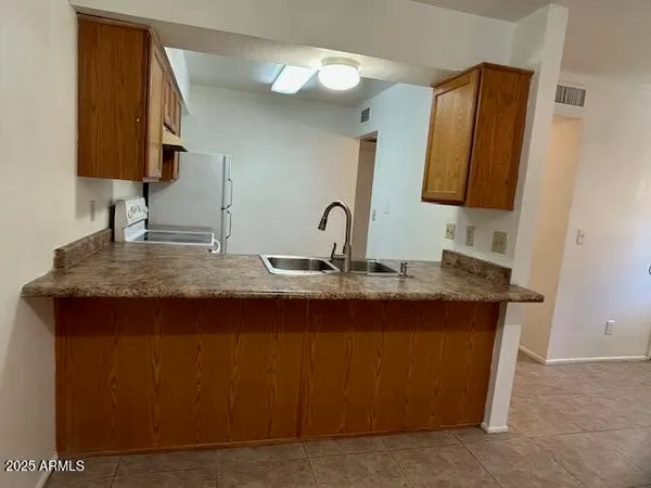 a bathroom with a granite countertop sink a mirror and vanity