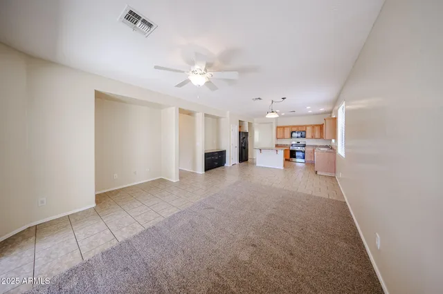 a view of a livingroom with furniture and a ceiling fan
