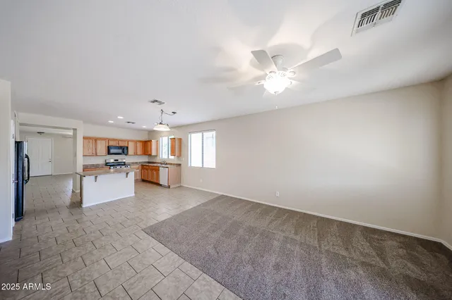 a view of kitchen with refrigerator and window