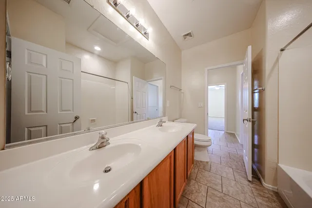 a bathroom with a double vanity sink mirror and double