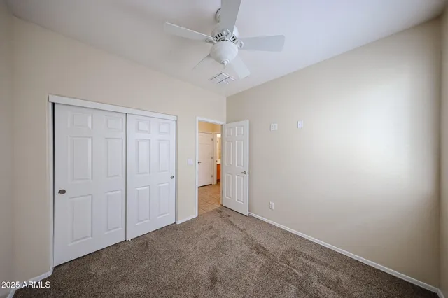 an empty room with a ceiling fan