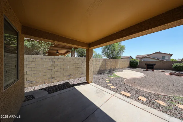 a backyard of a house with yard and outdoor seating