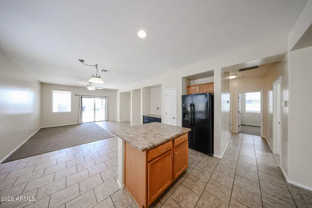 a kitchen with a refrigerator and a sink