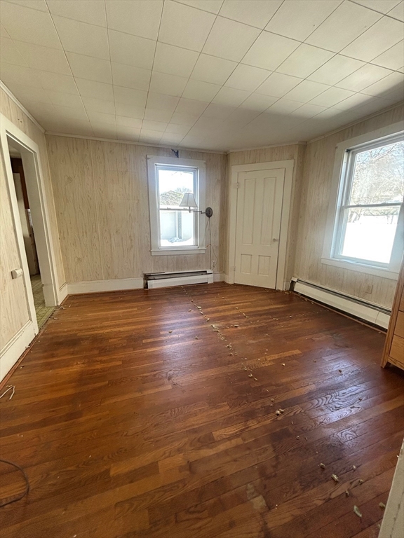1 Dunlap Street Salem, MA 01970 - Photo 9 of 31 an empty room with wooden floor and windows with curtains