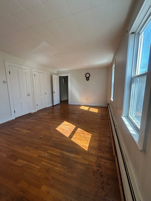 1 Dunlap Street Salem, MA 01970 - Photo 10 of 31 a view of an empty room with wooden floor and a window
