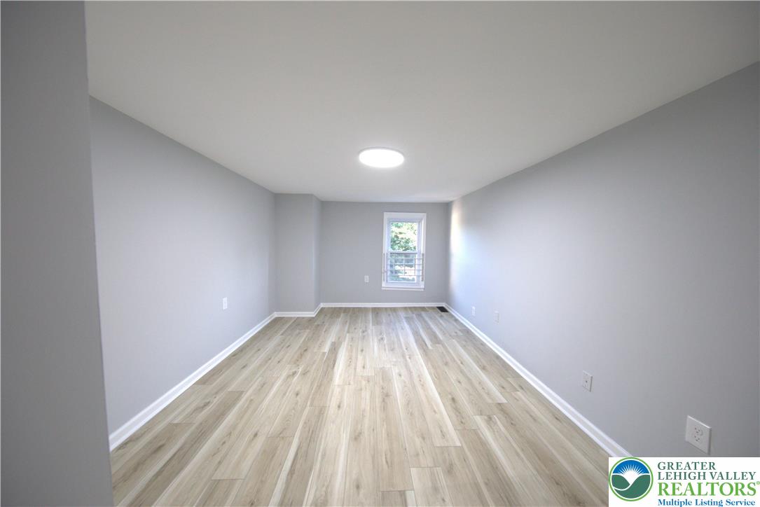910 Butler Street Easton, PA 18042 - Photo 12 of 29 a view of room with window and hardwood floor