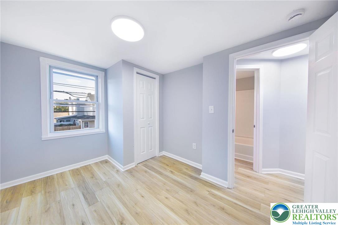 910 Butler Street Easton, PA 18042 - Photo 15 of 29 a view of an empty room with wooden floor and window