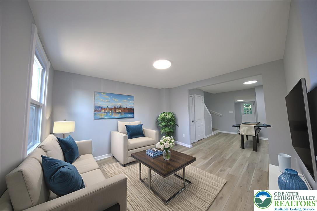 910 Butler Street Easton, PA 18042 - Photo 3 of 29 a living room with furniture and a flat screen tv