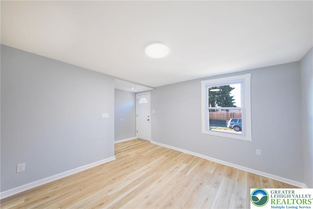 910 Butler Street Easton, PA 18042 - Photo 4 of 29 a view of an empty room with wooden floor and a window