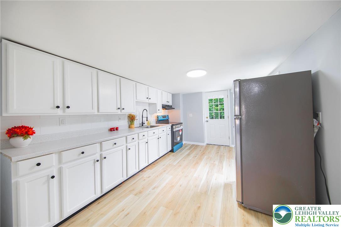 910 Butler Street Easton, PA 18042 - Photo 8 of 29 a kitchen with granite countertop white cabinets and white appliances