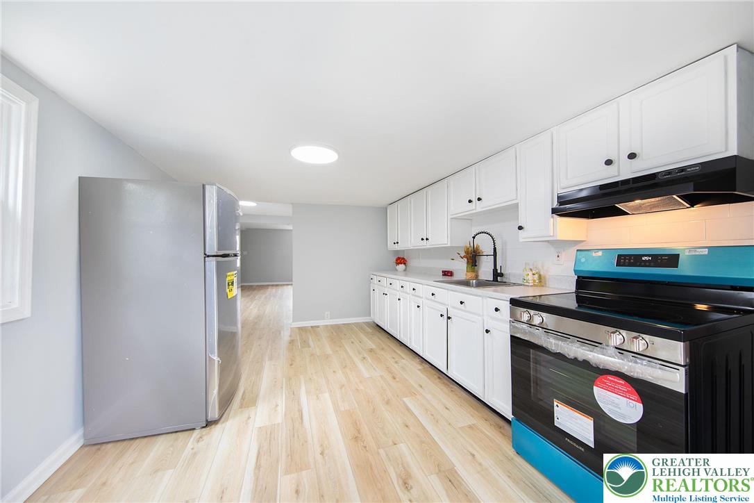 910 Butler Street Easton, PA 18042 - Photo 10 of 29 a kitchen with granite countertop a sink cabinets and stainless steel appliances
