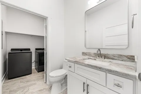 a kitchen with stainless steel appliances granite countertop a refrigerator a stove and a refrigerator with wooden floor