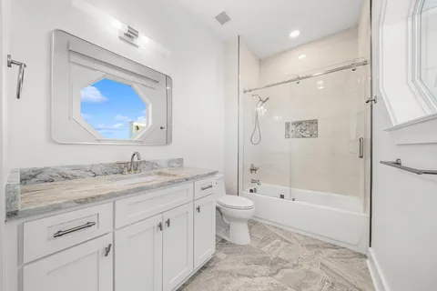 a bedroom with a bed and flat tv screen