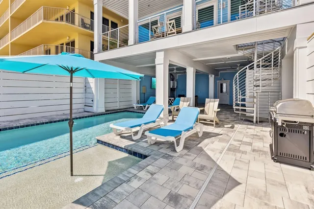 a view of a livingroom with wooden floor and furniture