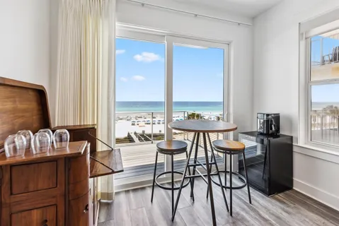 a living room with furniture and a floor to ceiling window