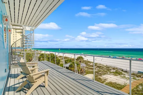 a view of balcony with two chairs and wooden floor