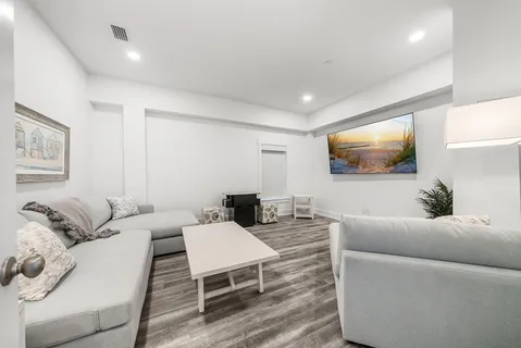 a bathroom with a granite countertop sink a toilet and shower
