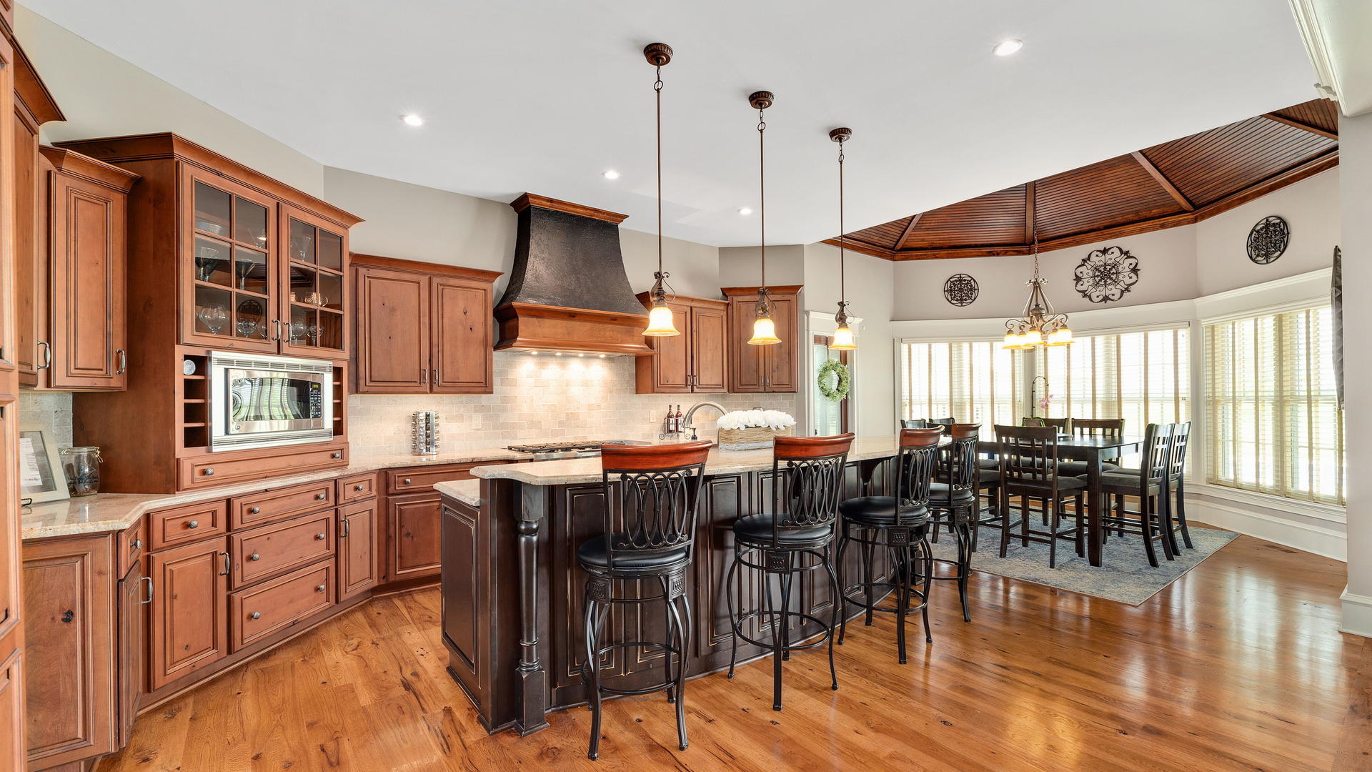 44-w230 Scott Road Sugar Grove, IL 60554 - Photo 8 of 44 a open kitchen with stainless steel appliances granite countertop a stove top oven a dining table and chairs with wooden floor