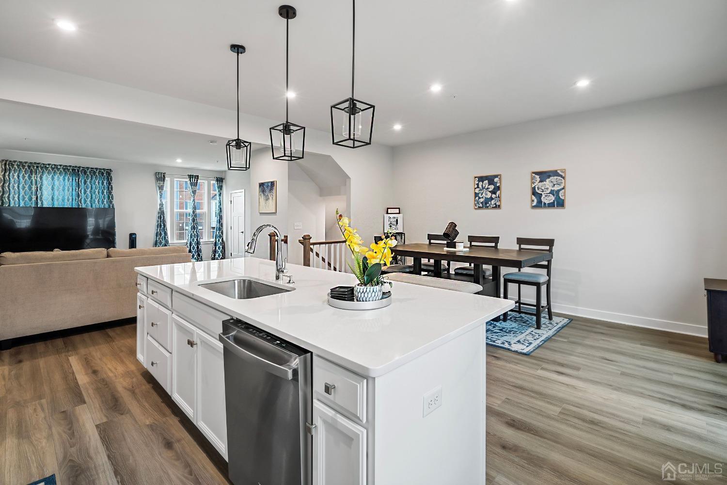 26 American Way Cliffwood, NJ 07721 - Photo 15 of 32 a kitchen with a sink a counter space and wooden floor