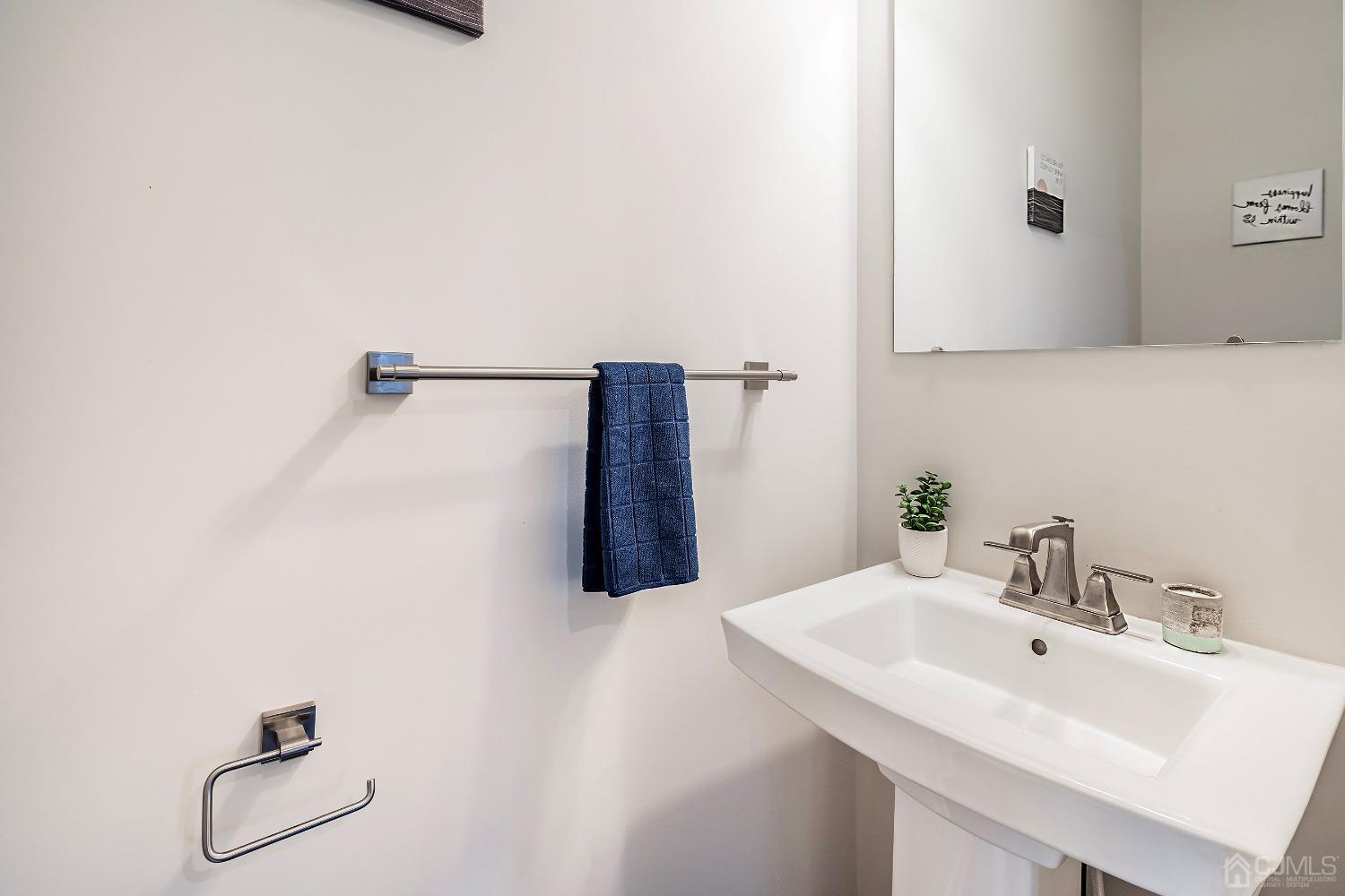 26 American Way Cliffwood, NJ 07721 - Photo 21 of 32 a bathroom with a sink and mirror