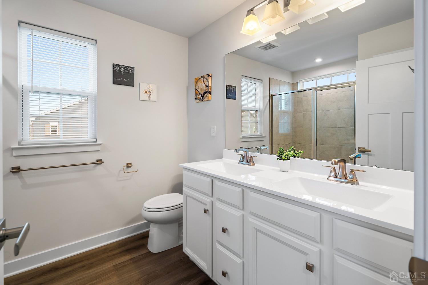 26 American Way Cliffwood, NJ 07721 - Photo 23 of 32 a bathroom with a double vanity sink toilet and a mirror