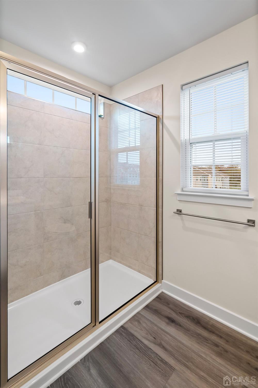 26 American Way Cliffwood, NJ 07721 - Photo 24 of 32 a bathroom with a glass shower door