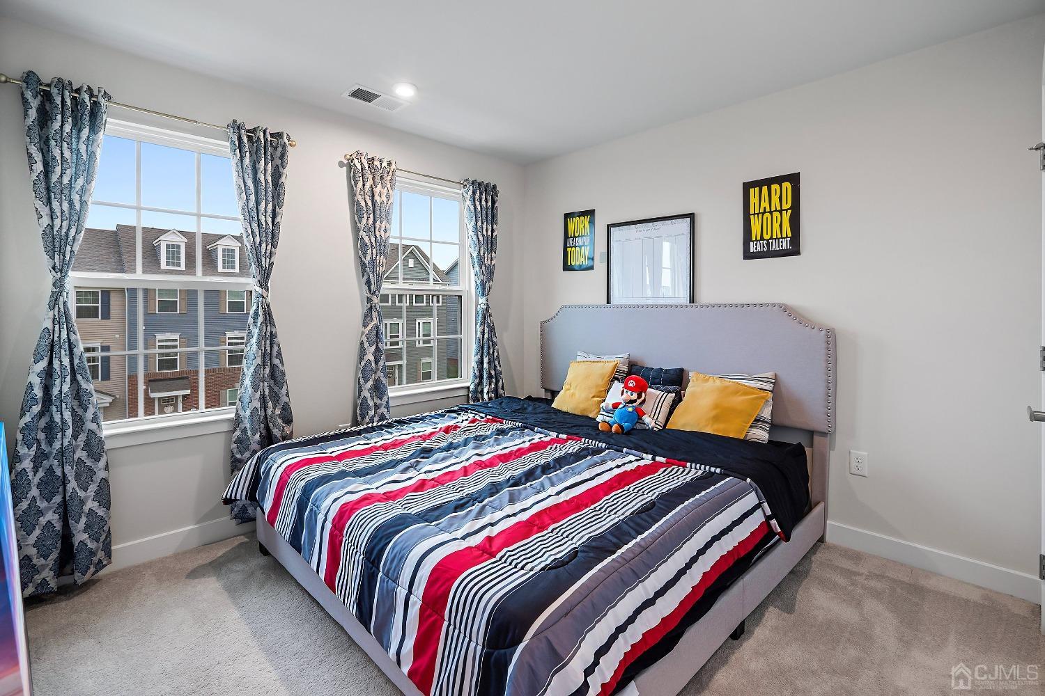 26 American Way Cliffwood, NJ 07721 - Photo 26 of 32 a bed sitting in a bedroom next to a window