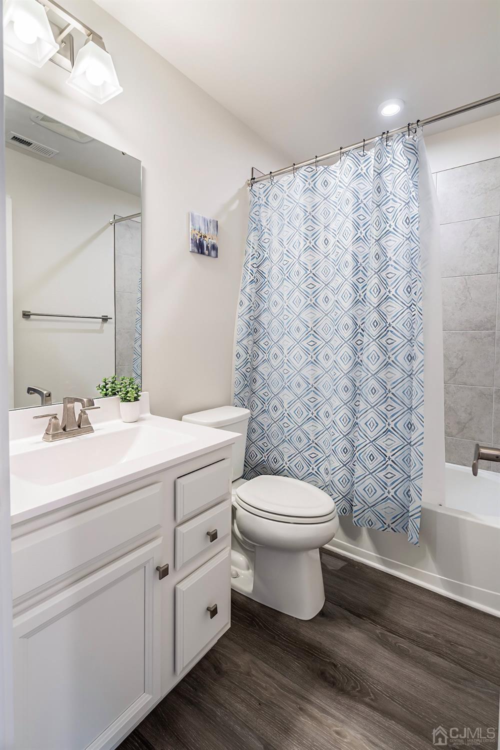26 American Way Cliffwood, NJ 07721 - Photo 27 of 32 a bathroom with a sink a toilet and shower