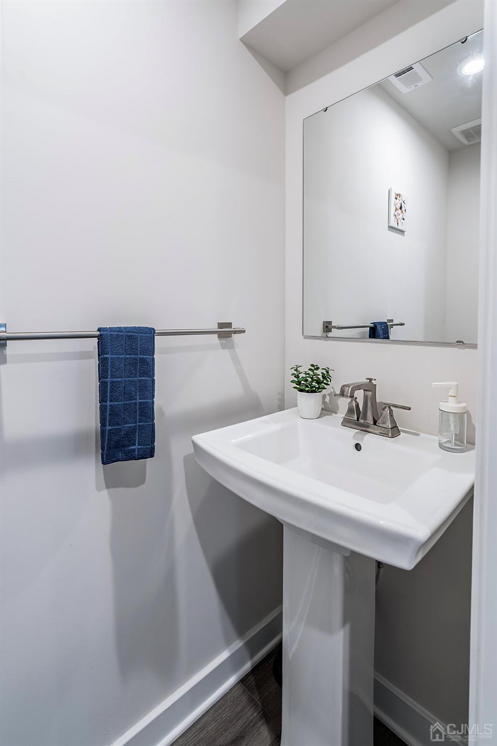 26 American Way Cliffwood, NJ 07721 - Photo 8 of 32 a bathroom with a sink and a mirror