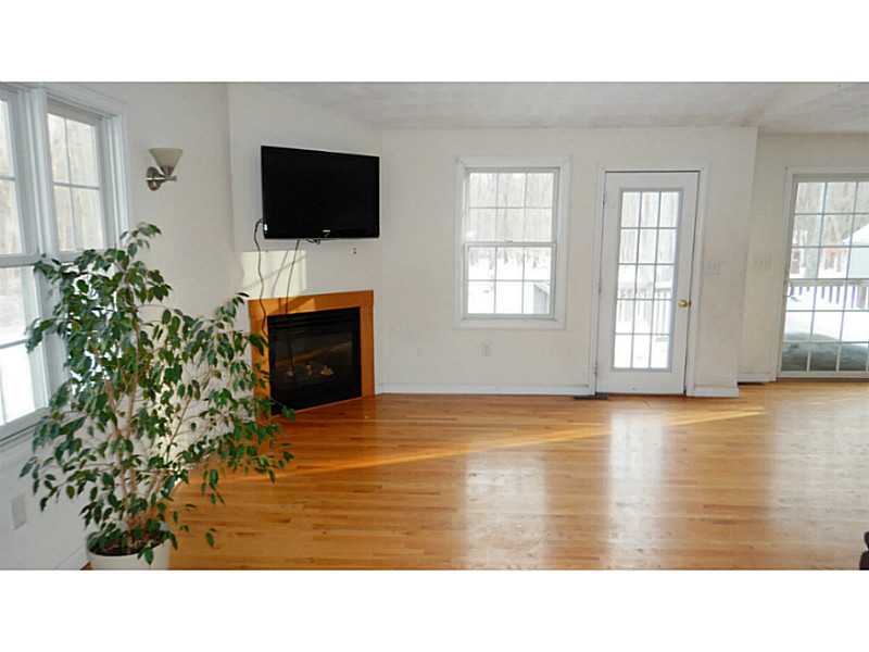 250 Hope Furnace Road Coventry, RI 02831 - Photo 7 of 15 Den/Family/Great Room. Family room with fireplace opens to dining area and slider to deck.